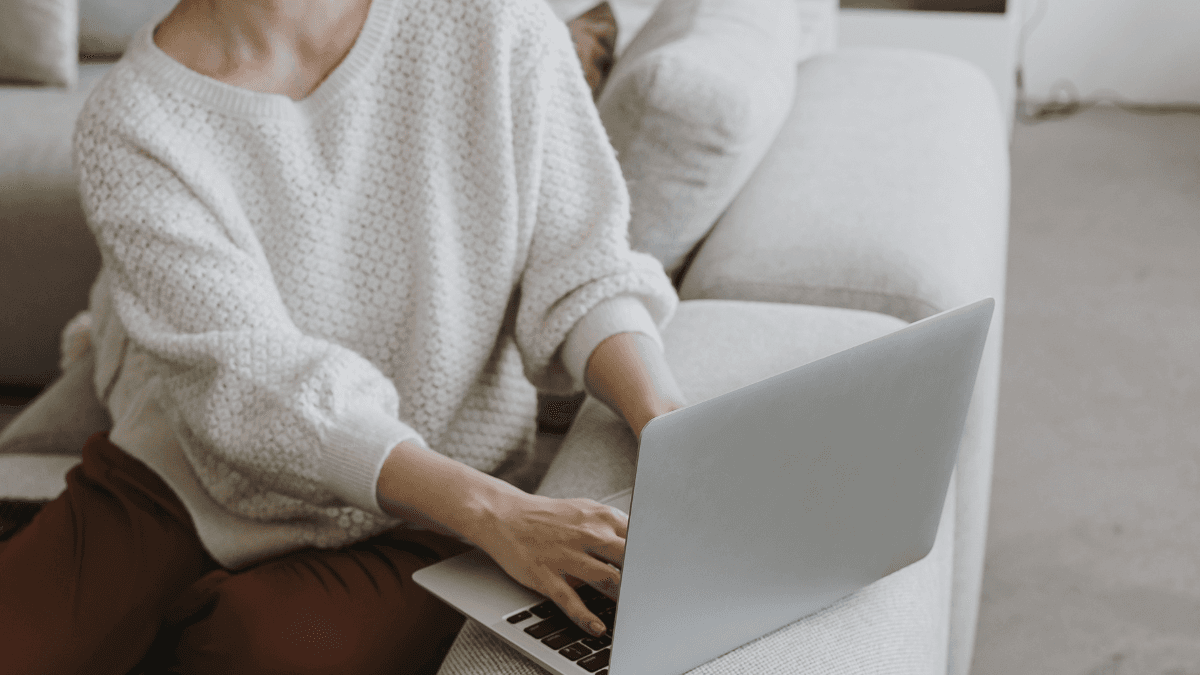 Person working thoughtfully on a laptop at home