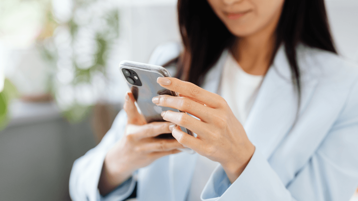 Person checking a phone in a bright everyday setting